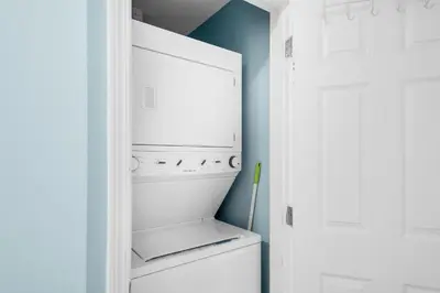 a white refrigerator in a kitchen with blue walls at Laketown Wharf 2118 in Panama City Beach