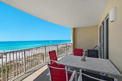 a balcony with a table and chairs and the ocean at Ocean Villa 405 in Panama City Beach
