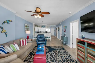 a living room with a couch and a ceiling fan at Ocean Villa 405 in Panama City Beach