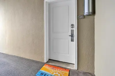 a book sitting on the floor in front of a door at Grand Panama 1-409 in Panama City Beach