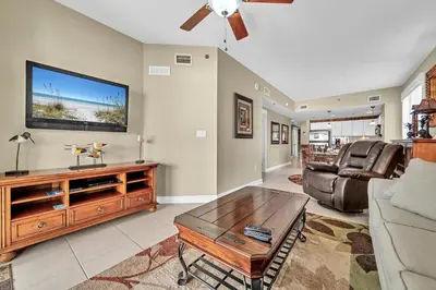 a living room with a couch and a tv at Grand Panama 1-409 in Panama City Beach