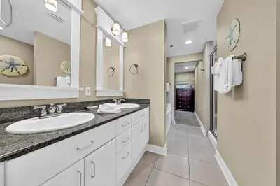 a bathroom with two sinks and a large mirror at Grand Panama 1-409 in Panama City Beach