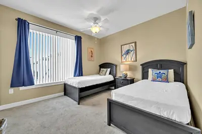 a bedroom with two beds and a window at Grand Panama 1-409 in Panama City Beach