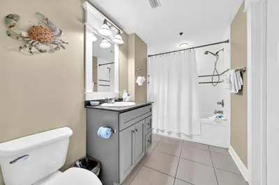 a bathroom with a toilet and a sink and a shower at Grand Panama 1-409 in Panama City Beach