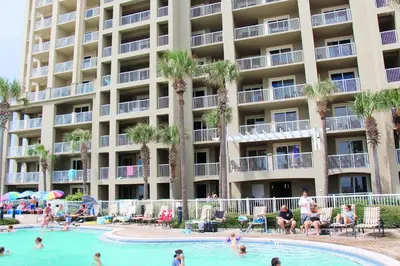 a hotel with a swimming pool with people in it at Grand Panama 1-409 in Panama City Beach