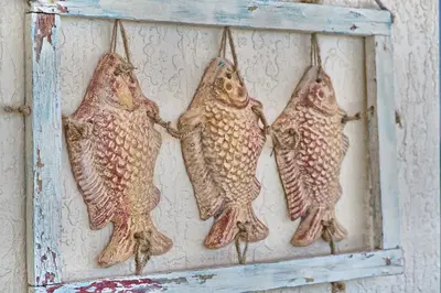 three fish are hanging on a wall at Cozy Oceanfront Condo with Beachside Pool - Unit 1602 in Panama City Beach