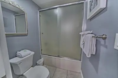 a bathroom with a toilet and a shower at Cozy Oceanfront Condo with Beachside Pool - Unit 1602 in Panama City Beach