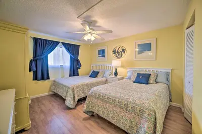a bedroom with two beds and a ceiling fan at Beachfront PCB Escape with Free Beach Chair Services in Panama City Beach
