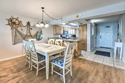 a kitchen and dining room with a table and chairs at Beachfront PCB Escape with Free Beach Chair Services in Panama City Beach