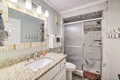 a bathroom with a toilet and a sink and a shower at Beachfront PCB Escape with Free Beach Chair Services in Panama City Beach