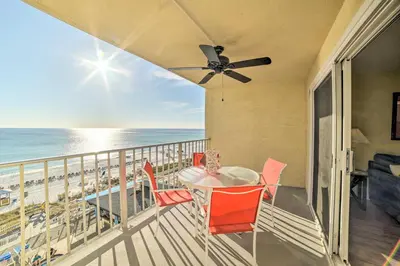 a balcony with a table and chairs and the ocean at Beachfront PCB Escape with Free Beach Chair Services in Panama City Beach