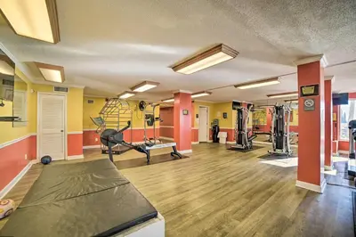 a fitness room with a gym with tread machines at Beachfront PCB Escape with Free Beach Chair Services in Panama City Beach