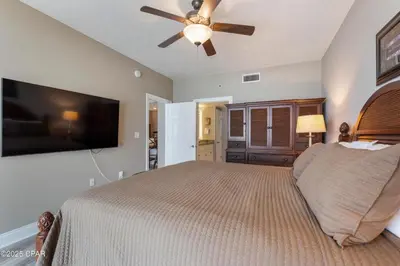 a bedroom with a bed and a ceiling fan at Astonishing Beacfront Condo with 360 sqft Balcony Facing the Ocean - Unit 0302 in Panama City Beach