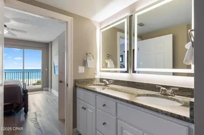 a bathroom with two sinks and a large mirror at Astonishing Beacfront Condo with 360 sqft Balcony Facing the Ocean - Unit 0302 in Panama City Beach