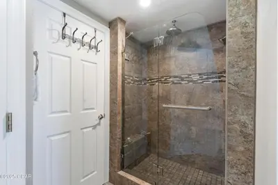 a bathroom with a shower with a glass door at Astonishing Beacfront Condo with 360 sqft Balcony Facing the Ocean - Unit 0302 in Panama City Beach