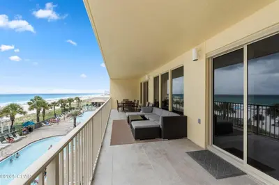 a balcony with a couch and a view of the beach at Astonishing Beacfront Condo with 360 sqft Balcony Facing the Ocean - Unit 0302 in Panama City Beach