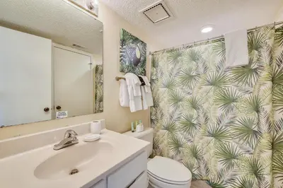 a bathroom with a sink and a toilet and a shower at Commodore Resort #707 by Book That Condo in Panama City Beach