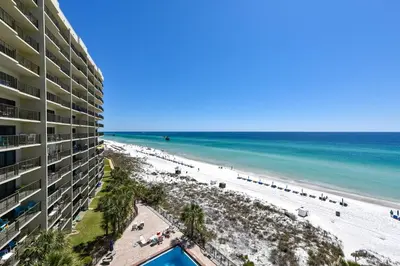 a view of the beach from the balcony of a resort at Commodore Resort #707 by Book That Condo in Panama City Beach