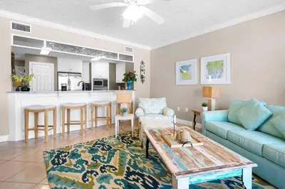 a living room with a couch and a table at Hidden Dunes 402 in Panama City Beach