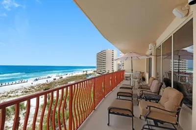 a balcony with chairs and a view of the beach at Hidden Dunes 402 in Panama City Beach