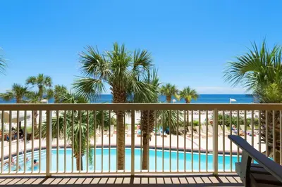 a view of a pool from the balcony of a resort at Calypso 1-203 East in Panama City Beach