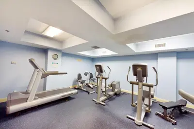 a gym with several tread machines in a room at Calypso 1-203 East in Panama City Beach