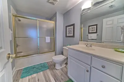 a bathroom with a shower and a sink and a toilet at Spacious Tropical Condominium at 17th Floor with Beach and Pool Access - Unit 1707 in Panama City Beach