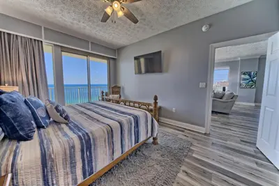 a bedroom with a bed with a view of the ocean at Spacious Tropical Condominium at 17th Floor with Beach and Pool Access - Unit 1707 in Panama City Beach
