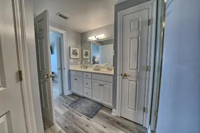 a bathroom with a sink and a mirror at Spacious Tropical Condominium at 17th Floor with Beach and Pool Access - Unit 1707 in Panama City Beach