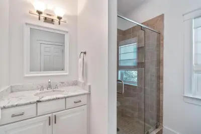 a white bathroom with a sink and a shower at Pure Joy* in Santa Rosa Beach