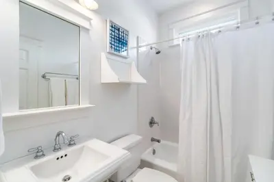 a white bathroom with a sink and a toilet at Pure Joy* in Santa Rosa Beach