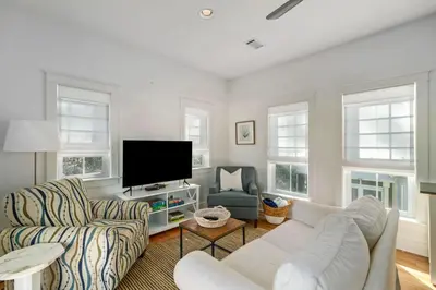a living room with a couch and a flat screen tv at Pure Joy* in Santa Rosa Beach
