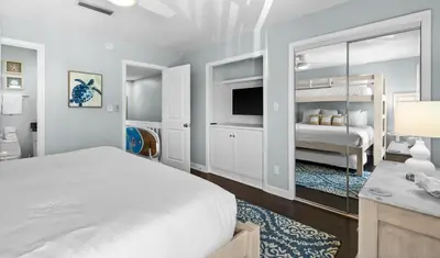 a white bedroom with a bed and a tv at Silver Sands Townhomes Unit 4 in Inlet Beach