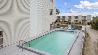 a swimming pool in front of a building at Silver Sands Townhomes Unit 4 in Inlet Beach