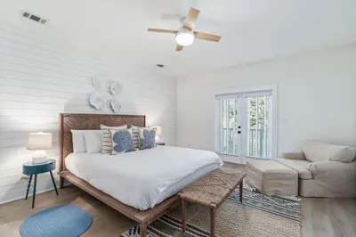 a white bedroom with a bed and a couch at 248 Beach Bike Way in Inlet Beach