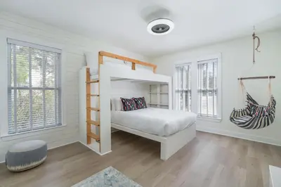 a white bedroom with a bunk bed and windows at 248 Beach Bike Way in Inlet Beach
