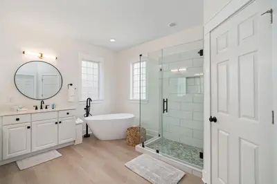 a white bathroom with a tub and a glass shower at 248 Beach Bike Way in Inlet Beach