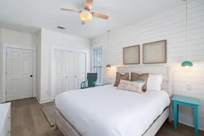 a bedroom with a white bed and a ceiling fan at 248 Beach Bike Way in Inlet Beach