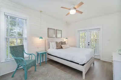 a bedroom with a bed and a table and chairs at 248 Beach Bike Way in Inlet Beach