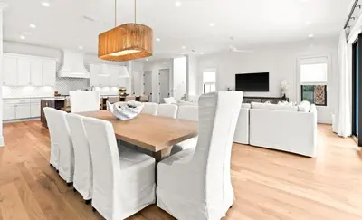 a dining room and living room with a table and chairs at 169 Lakeview Drive in Santa Rosa Beach