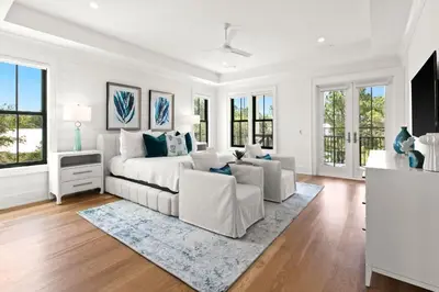 a white living room with a couch and a tv at 169 Lakeview Drive in Santa Rosa Beach