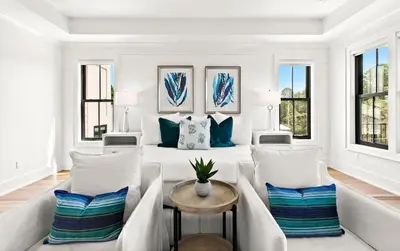 a white room with a bed and two chairs at 169 Lakeview Drive in Santa Rosa Beach
