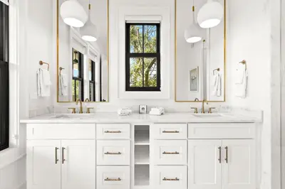 a white bathroom with two sinks and two mirrors at 169 Lakeview Drive in Santa Rosa Beach