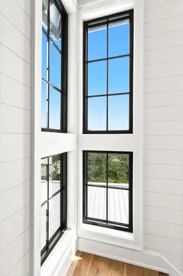 a room with four windows and a wooden floor at 169 Lakeview Drive in Santa Rosa Beach