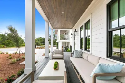 a porch with a couch on a house at 169 Lakeview Drive in Santa Rosa Beach