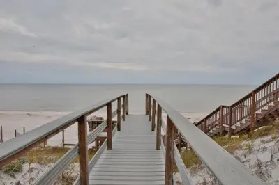 a wooden boardwalk leading to the beach at Chivas Apartment on 30A in Santa Rosa Beach