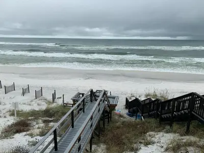 a stairway leading to a beach with the ocean at Chivas Apartment on 30A in Santa Rosa Beach
