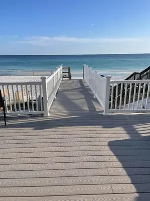 a wooden boardwalk leading to a beach with the ocean at Chivas Apartment on 30A in Santa Rosa Beach