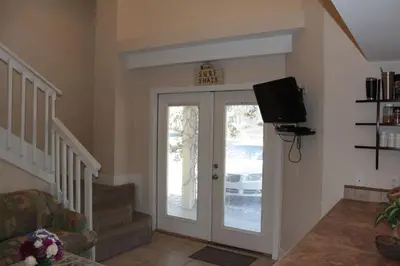 a living room with a door and a sign on the wall at Chivas Apartment on 30A in Santa Rosa Beach