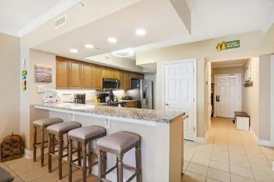 a kitchen with a counter with bar stools at Flipflop Paradise Unit 625 in Panama City Beach